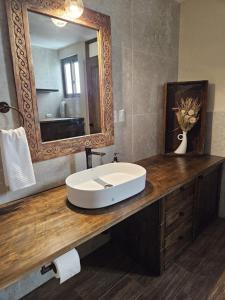 a bathroom with a sink and a mirror at Loft Candelaria Antigua in Antigua Guatemala