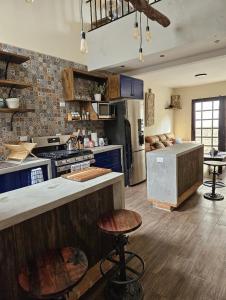 a large kitchen with a stove and a counter top at Loft Candelaria Antigua in Antigua Guatemala