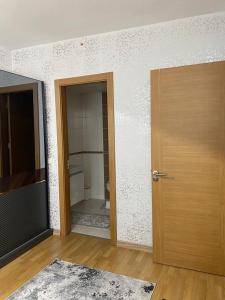 an empty room with a door and a bathroom at Sweety home in Esenyurt