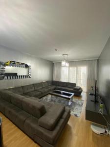 a living room with a large couch and a television at Sweety home in Esenyurt