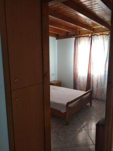 a bedroom with a bed and a window at A CASA D'IRENE in Votsalákia