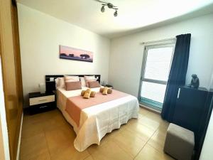 a bedroom with a bed with two teddy bears on it at Casa La Olas in Morro del Jable