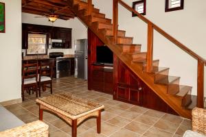 a living room with a staircase and a kitchen at X'tan Ha- The Waterfront in San Pedro