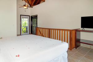 a bedroom with a bed and a flat screen tv at X'tan Ha- The Waterfront in San Pedro