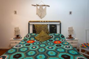 a bedroom with a bed with a quilt on it at Departamento Tarquinio en Tigre, Buenos Aires in Tigre