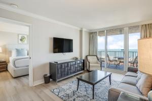 a living room with a couch and a television at Marco Beach Ocean Resort 1102 in Marco Island