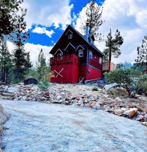 ein großes rotes Haus auf einem Steinhaufen in der Unterkunft 1 B1B lake cabin/walk to lake/Boulder bay park in Big Bear Lake