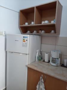a kitchen with a white refrigerator and a coffee maker at Arti Studio in Braşov