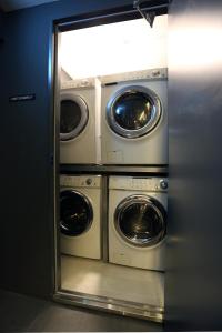 two washer and dryers are in a room at Hotel 8 Hours in Seoul