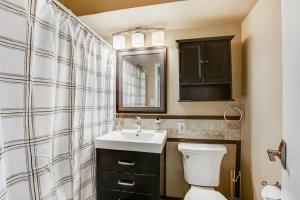 a bathroom with a sink and a toilet and a mirror at Central Respite in Seattle