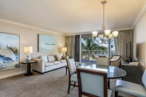 a living room with a dining table and a couch at Marco Beach Ocean Resort 714 in Marco Island