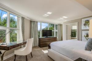 a bedroom with a bed and a desk and a television at Marco Beach Ocean Resort 714 in Marco Island