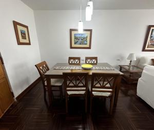 a room with a dining room table and chairs at San Isidro Olivar 2 bedroom Apartment in Lima