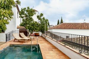 a swimming pool on the balcony of a house at Apartamentos turísticos EL PATIO DEL NOGAL in Guadalupe