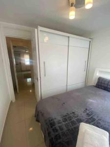 a bedroom with a bed and a large closet at Lovely 1 bedroom flat in Chigwell