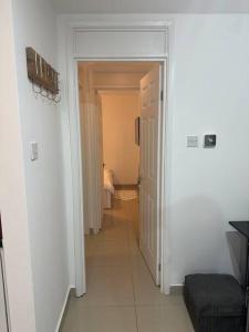 a hallway with a door leading to a room with a toilet at Lovely 1 bedroom flat in Chigwell