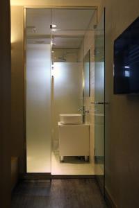 a bathroom with a sink and a glass wall at Hotel 8 Hours in Seoul +26 photos