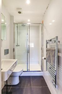 a bathroom with a shower and a toilet and a sink at Exceptionally Spacious Central Canterbury Home in Canterbury