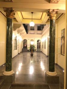 an empty hallway with columns in a building at Kecskeméti Rooms in Budapest