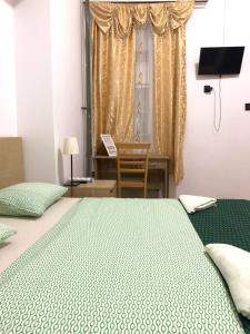 1 dormitorio con cama, escritorio y ventana en Kecskeméti Rooms, en Budapest