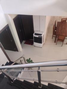 a view of a living room with a microwave at Away From Home, Furnished Apartment in Bhopal