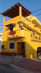 a yellow building with a door in front of it at Hotel Joya Del Mar in Barra de Navidad
