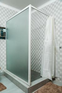 a shower with a glass door in a bathroom at Planet Golf - foxdale in Foxdale Estates