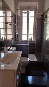 a bathroom with a sink and a toilet and a shower at Casa do Passadiço in Lisbon