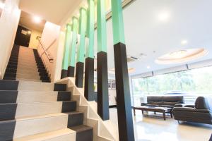 a lobby with a staircase with a colorful wall at Lavender Inn Nusa Bestari in Johor Bahru