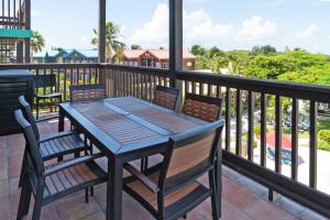 a table and chairs on a balcony with a view at X'tan Ha- The Waterfront in San Pedro