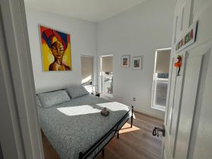 a bedroom with a bed and a painting on the wall at Cartagena Room in Seattle