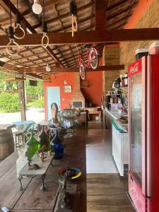 uma cozinha com paredes vermelhas e uma mesa com vasos em Chácara de Alto Padrão em Nova Iguaçu