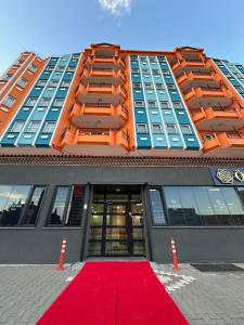 a building with a red carpet in front of a building at Özdemir Inn Otel in Balıkesir