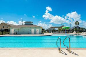 a swimming pool with a building in the background at The Swordfish Sanctuary in Galveston