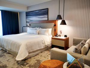 a hotel room with a large bed and a couch at The Westin Monterrey Valle in Monterrey +65 photos
