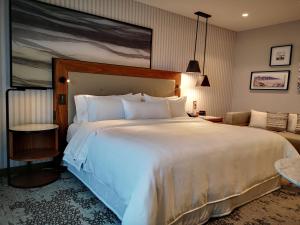 a bedroom with a large white bed and a couch at The Westin Monterrey Valle in Monterrey