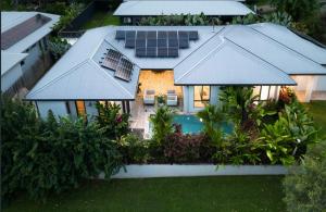 an aerial view of a house with solar panels on the roof at Flagship Villa in Trinity Beach +20 photos