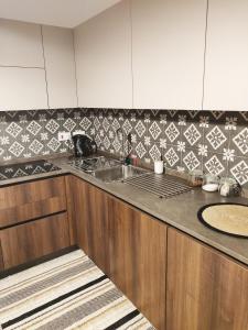 a kitchen with a sink and a counter top at Central Malta Apartment in Birkirkara