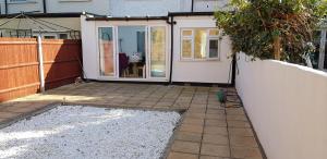 an outside view of a house with a patio at Mirandas Place in Gillingham