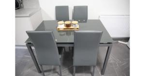 a black dining room table with two chairs at Cricklewood Deluxe Ensuite Room in London
