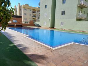 a swimming pool in the middle of a building at Apartamento en Tenerife- Candelaria Islas Canarias in Candelaria