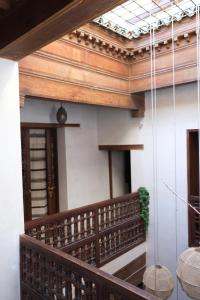 a balcony of a building with a wooden ceiling at Dar Rafti in Fez