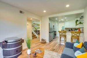 a living room with a blue couch and a kitchen at 1 Mi to State Beach! Dog-Friendly Dana Point Condo in Dana Point