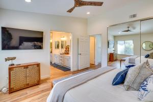 a bedroom with a large bed and a bathroom at 1 Mi to State Beach! Dog-Friendly Dana Point Condo in Dana Point