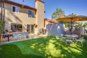 a backyard with a table and an umbrella at 1 Mi to State Beach! Dog-Friendly Dana Point Condo in Dana Point