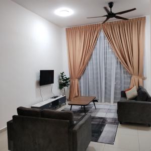 a living room with two couches and a ceiling fan at ART CASIA HOMESTAY BERTAM in Kepala Batas