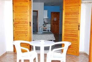 a white table and chairs in a room at Elena Studios in Patitiri