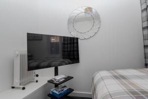 a bedroom with a mirror and a bed and a table at The house in Barking