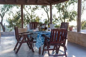 a table with three chairs and a blue tablecloth on it at Casa Giardinello in Ribera