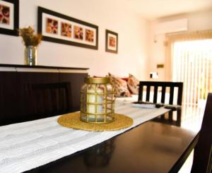a dining room table with a jar on top of it at Mendoza Aparts - Con cochera incluida in Villa María